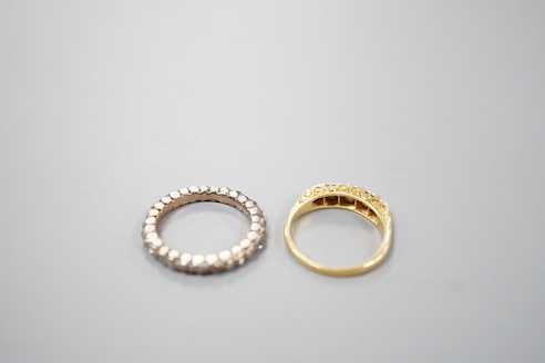 A 19th century yellow metal and rose diamond set full eternity ring, size L/M and an early 20th century yellow metal and graduated split pearl ring, size K/L, gross weight 5.8 grams.